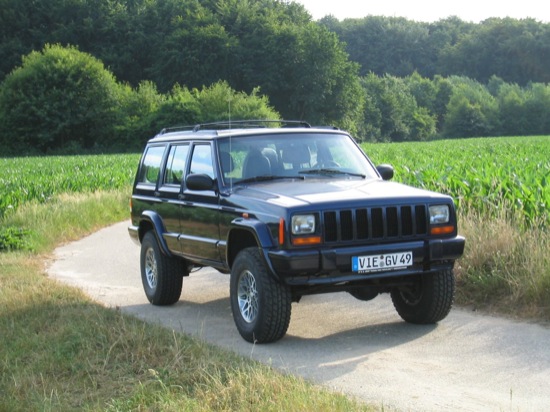 blue 1997 Jeep Cherokee on country road